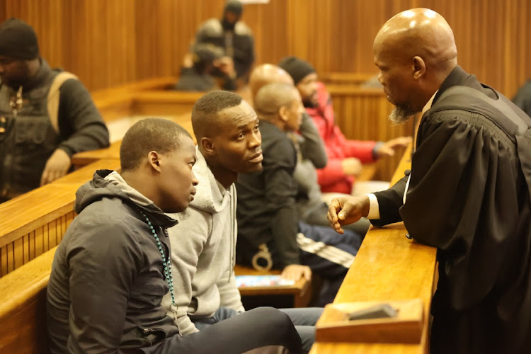 Defence lawyer, Sipho Ramosepele with two of the five accused of murdering Bafana Bafana captain ,Senzo Meyiwa.