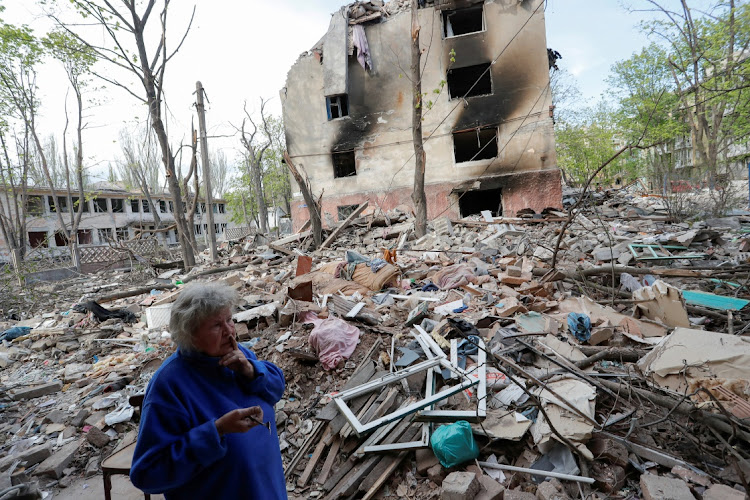 Local resident and nursery teacher Natalya Kalugina, 64, stands in a courtyard near a block of flats, which was destroyed during Ukraine-Russia conflict in the southern port city of Mariupol, Ukraine April 29, 2022.