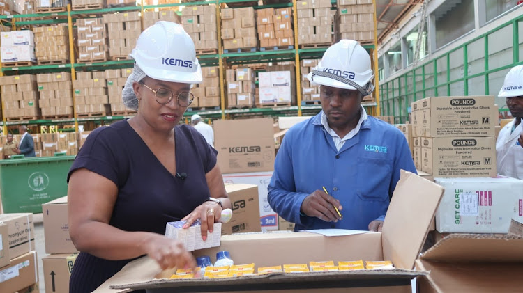 KEMSA CEO Terry Ramadhani Kiunge and KEMSA staff Leonard Ngeno during an exclusive media tour at its new warehouse in Embakasi Nairobi on April 4, 2023. /WINNIE WANJIKU