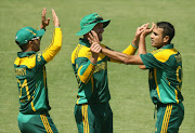 South African bowler Imran Tahir (R) celebrates a wicket with captain AB de Villiers (C) and JP Duminy (L) during the match between Australia and South Africa in the one day international tri-series which includes Zimbabwe at the Harare Sports Club, on August 27, 2014.