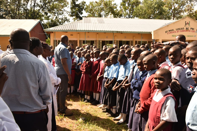 Bumula MP Jack Wamboka addressing pupils and teachers at Lunao primary school after the distribution of the menstrual cups