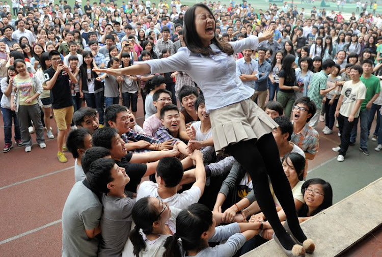 Students who sat gaokao celebrate after passing the exam to join their favourite colleges.