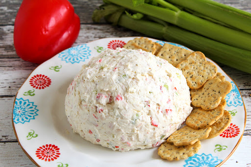Crab Salad Cheese Ball on a plate with crackers.