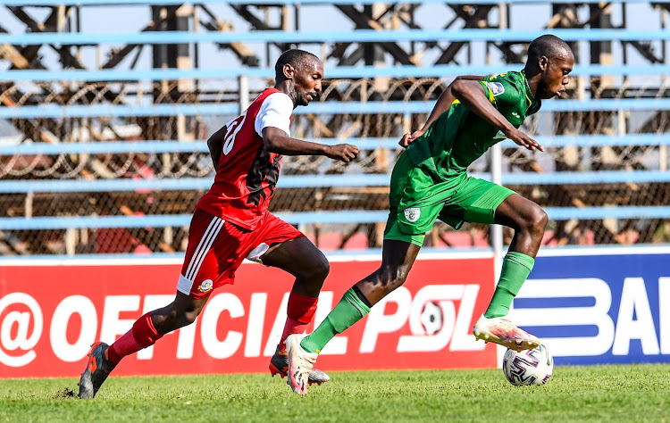 Evidence Makgopa of Baroka FC is challenged by Thabo Rakhale of Tshakhuma during the DStv Premiership match in Thohoyandou.