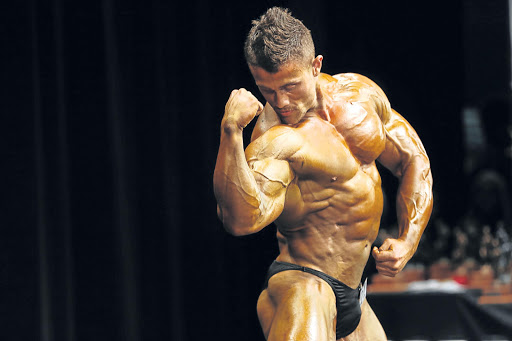 Louis Bessinger flexes his muscles during the Junior over 75kg division of the Body Building South Africa Border Championships held at the Guild Theatre over the weekend. Picutre ALAN EASON