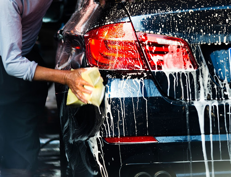 Stock image of a man washing a car. Image: 123RF/hxdbzxy