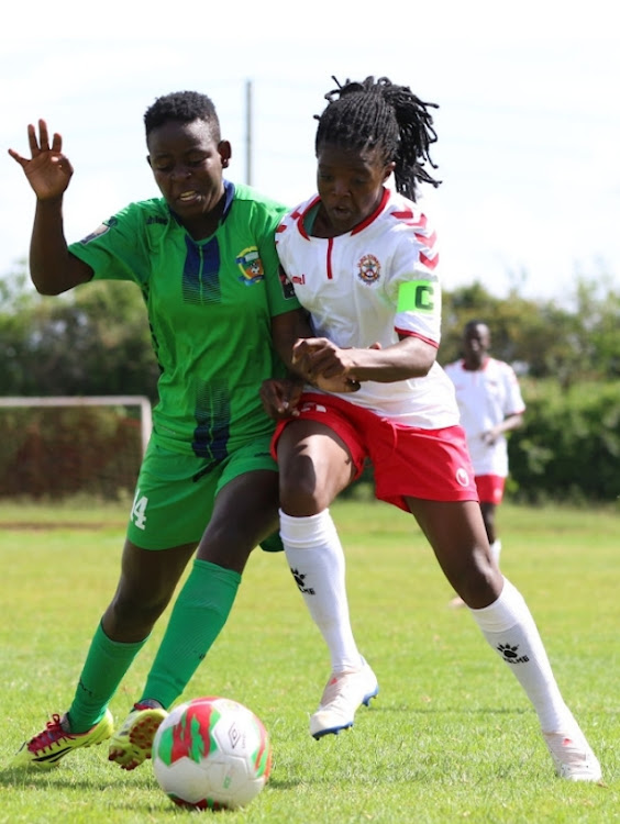 Vihiga's Jentrix Shikangwa (left) fights for the ball with Ulinzi's Diana Shakava