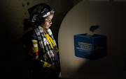 A voter marks her ballot paper in a booth at the Mavuno polling centre during the Presidential election in Goma, North Kivu province of the Democratic Republic of Congo on Wednesday.