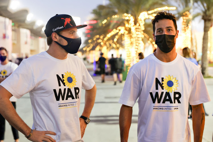 Max Verstappen (left) and Daniel Ricciardo talk while wearing T-shirts promoting peace and sympathy with Ukraine prior to F1 testing at Bahrain International Circuit on March 9.