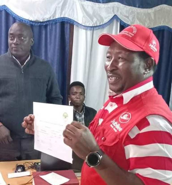 National security and administration parliamentary committee chairman Peter Mwathi shows his IEBC clearance certificate to contest for his Limuru MP seat on Monday, May 30.