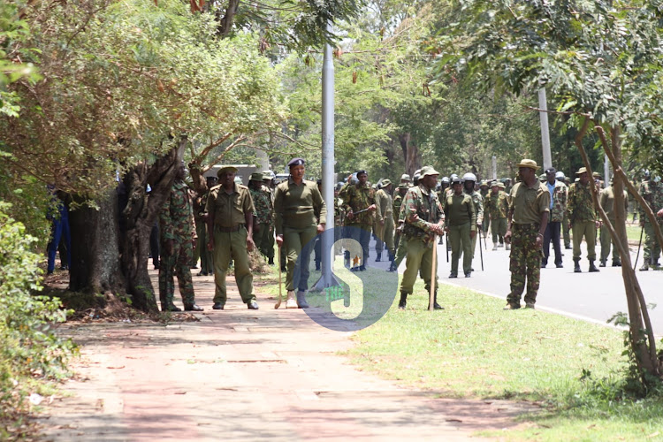 Police officers form layers of barriers to beef up security along the road leading to Kisumu State Lodge awaiting Azimio La Umoja protesters on March 17, 2023