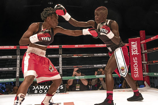 Smangele Hadebe, left, exchanges the leather with Ellen 'Tigress' Simwaka during the Africa Rising boxing event at the Portuguese Hall in May. /Gallo Images / Dan Edwards