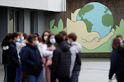 Schoolchildren wearing protective face masks, arrive to pay tribute to Samuel Paty, the French teacher who has beheaded on the streets of the Paris suburb of Conflans-Sainte-Honorine, at the Anne Franck college in Plescop, France, November 2, 2020. 