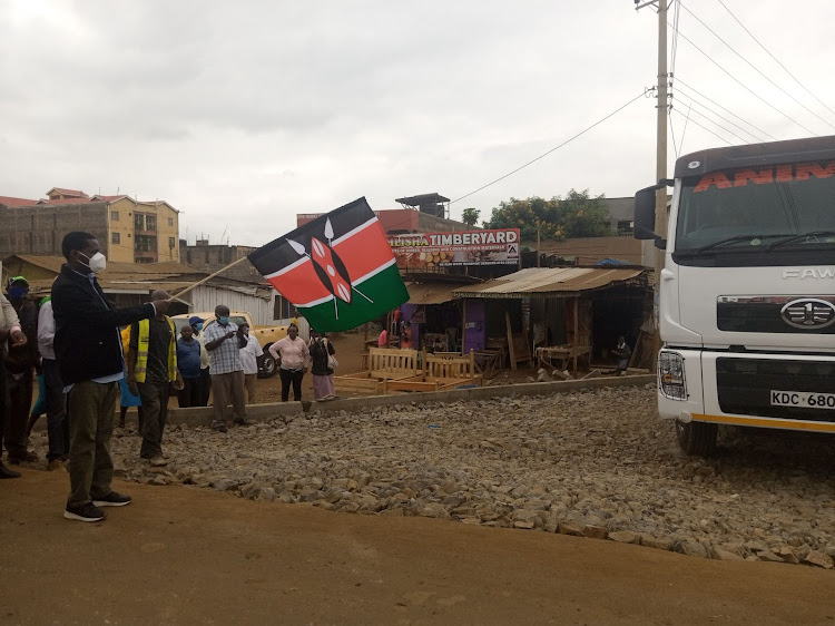 Agriculture CS Peter Munya flags off a cargo vehicle carrying a part of the last cosignement of the rice grain to be bought by the government at 85 shillings per kilo