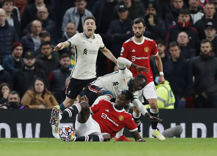 Manchester United's Paul Pogba fouls Liverpool's Naby Keita before being sent off after a VAR review at Old Trafford, Manchester on October 24, 2021