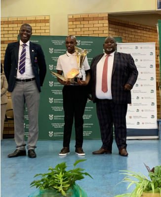 Top performing inmate Sandile Stangoni, centre, with justice and corrections minister Ronald Lamola, left, and MEC for education in the Northern Cape, Mac Jack.