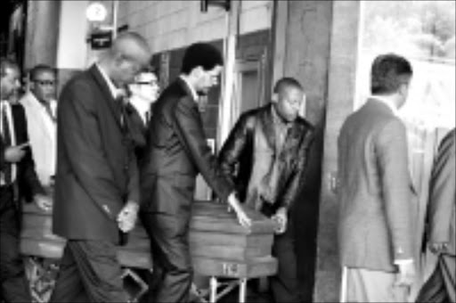 HONOUR: Arts and Culture Minister Pallo Jordan, family members and band members gathered at the OR Tambo International Airport with he coffin of the late Miriam Makeba. 11/11/08. Pic. Mohau Mofokeng. © Sowetan.