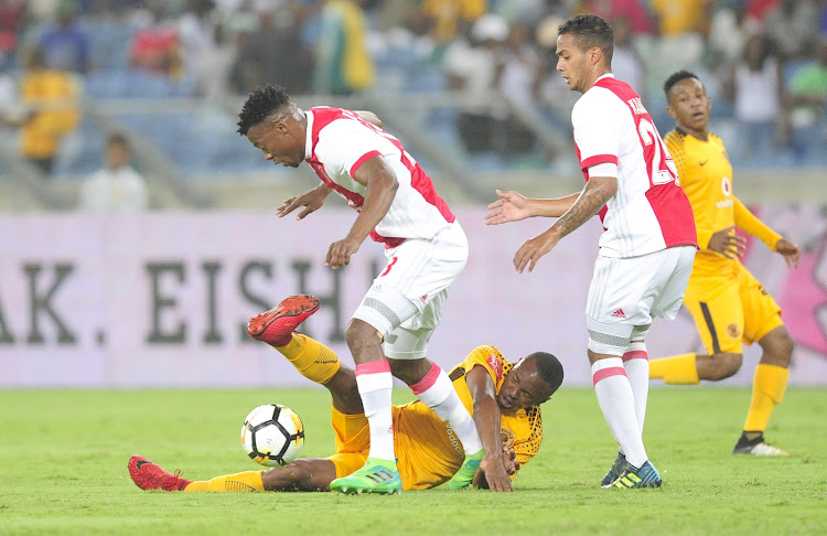 Bernard Parker of Kaizer Chiefs FC goes down fighting as Issac Nhlapo of Ajax Cape Town F.C. gets away with the ball during the Absa Premiership 2017/18 game between Kaizer Chiefs and Ajax Cape Town at Moses Mabhida Stadium, Durban on 16 December 2017.