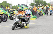 Oratilwe Phiri ( 10) entertains other bikers outside Moses Mabhida Stadium  during the ANC manifesto.