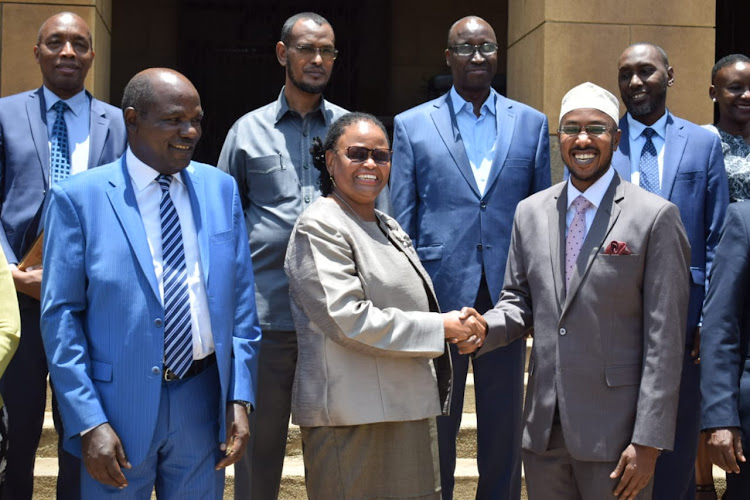 Chief Justice Martha Koome congratulations newly sworn in IEBC CEO Marjan Hussein in the presence of Commissioners at the Supreme Court on March 16, 2022