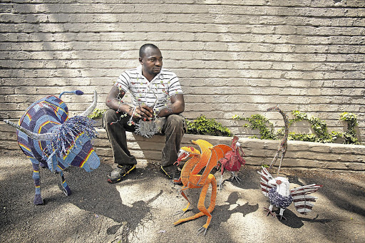 Tafadzwa Zvomuo sells his beaded goods in Parktown Picture: DANIEL BORN