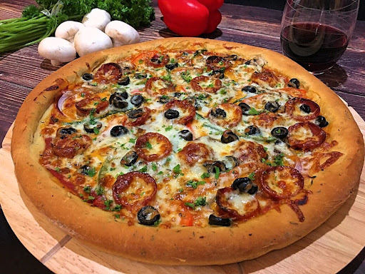 A delicious Pepperoni Pizza on a cutting board.