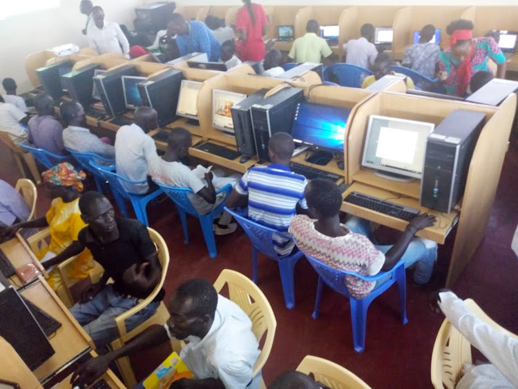 Youth refugees at Kakuma camp doing online jobs at an ICT facility.