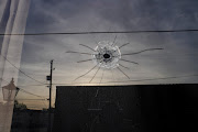 A bullet hole at the entrance of Mahogany Masterpiece Dance Studio the day after a shooting at a teenager's birthday party in Dadeville, Alabama, US, on April 16 2023.