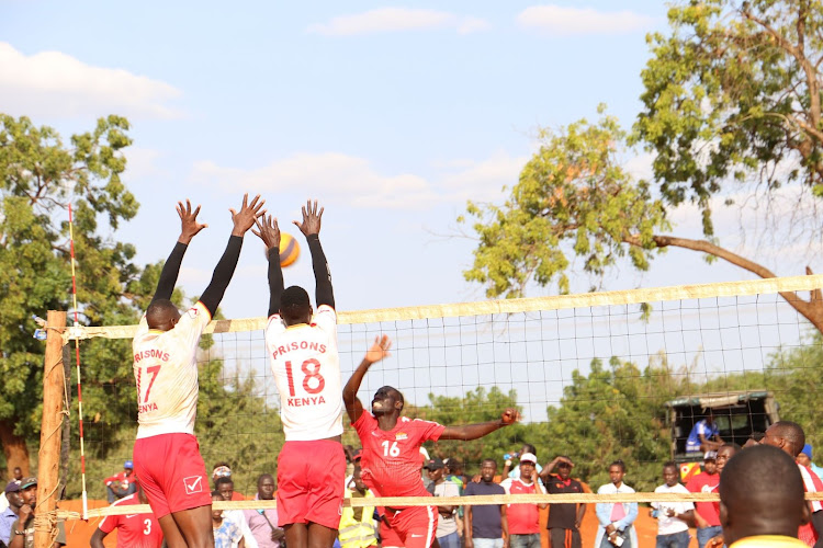 Kenya Prisons' duo of Sila Kipruto and Rodgers Kipkirui blocks Equity Bank's Martin Kiptoo during the Taita Taveta County Governor open tournament. yesterday