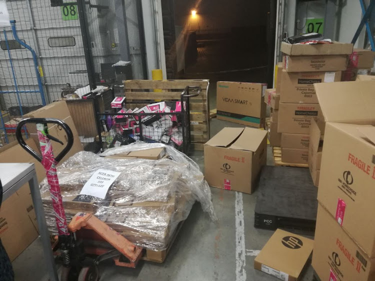 Scores of laptops and cellphones recovered after warehouse robbery.