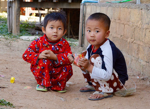 Myanmar-kids - Two beautiful children  -- like children everywhere -- playing games on a path in a village located on the edge of Inle Lake.