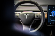 The US National Highway Traffic Safety Administration said Wednesday it is reviewing a recent software update by Tesla Inc. that allows drivers to play video games on a dashboard screen while the vehicle is moving.