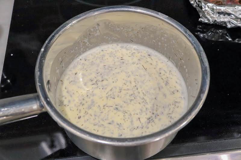 Grated Gruyere And Swiss Cheese, Heavy Cream, Thyme, And Garlic In A Saucepan.