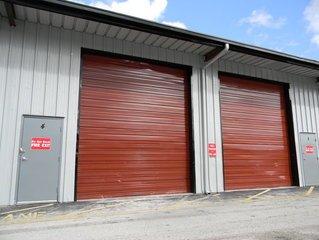 A building with red doorsDescription automatically generated with low confidence