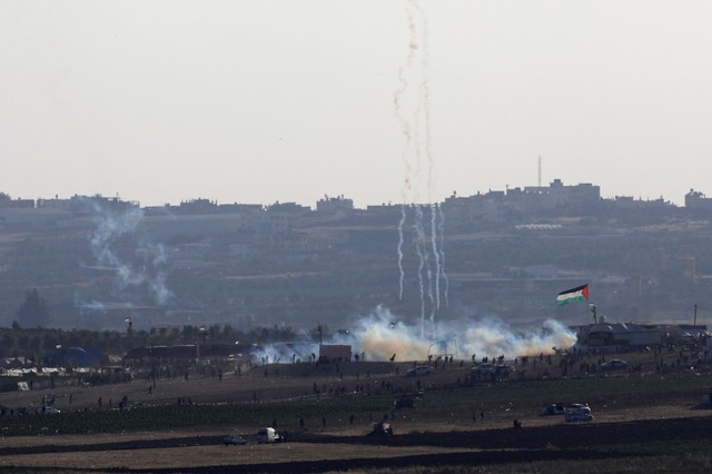 A smoke from the tear gas fired by Israeli troops can be seen from the Israeli side of the border between Israel and Gaza, at the northern Gaza Strip, May 14, 2018.