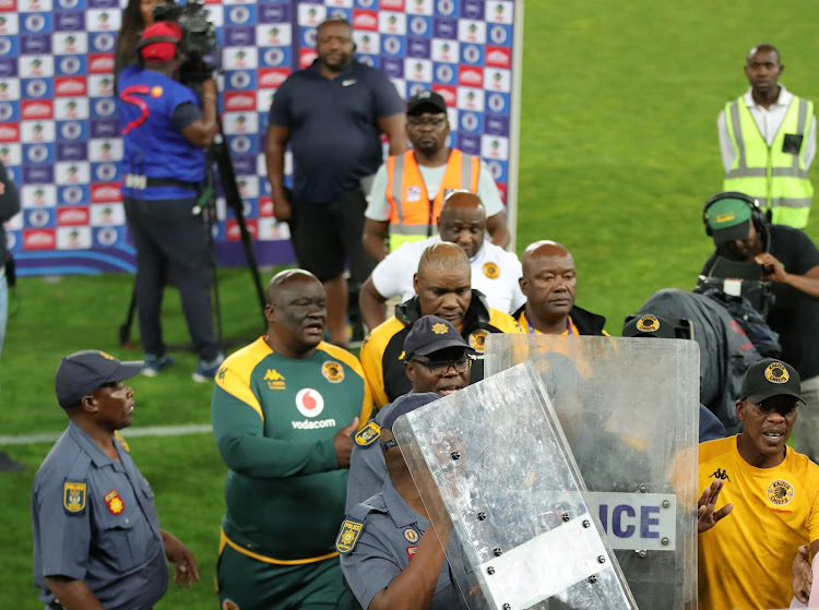 Kaizer Chiefs coach Molefi Ntseki escorted off the field by security after the 1-0 loss to SuperSport United at Peter Mokaba Stadium in Polokwane on September 20 2023.