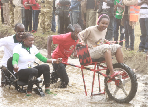 Participants race during the annual Hellsgate national park wheelbarrow race.