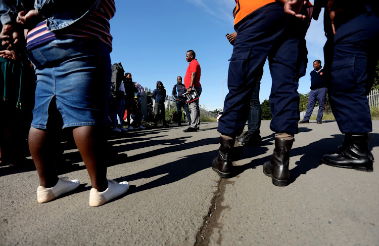 Cleaning staff contracted to a company that was awarded a tender by Transnet took to the street to demand their salaries. Picture: SANDILE NDLOVU.