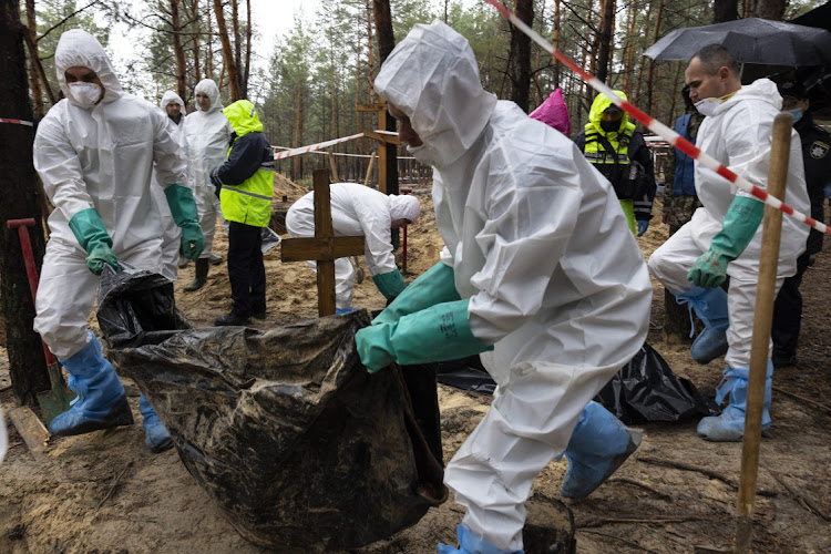 Rescue workers and forensic police exhume bodies from unidentified makeshift graves at the Pishanske cemetery on September 23, 2022 in Izium, Ukraine. A total of 447 bodies was exhumed from the gravesite, including 22 soldiers and 5 children, and the bodies will be examined by forensic officials for possible war crimes. In recent weeks, Ukrainian forces have reclaimed villages east and south of Kharkiv, as Russian forces have withdrawn from areas they've occupied since early in the war.