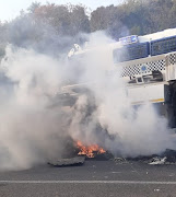 A Casspir pushes its way through burning debris on the M19 highway. 