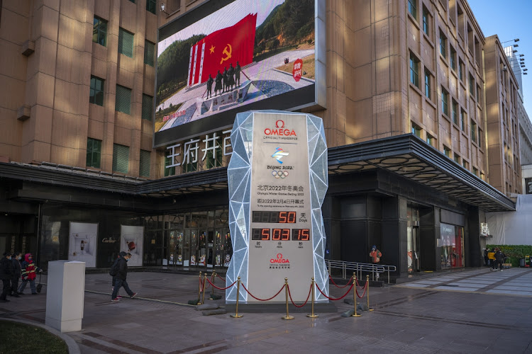 A propaganda movie is played in Beijing behind the countdown sign to the Beijing 2022 Winter Olympics. Picture: ANDREA VERDELLI/GETTY IMAGES