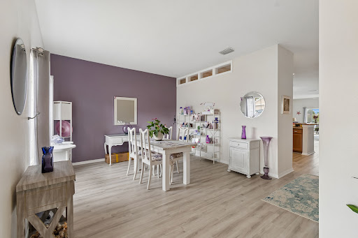 Dining room with white table and purple wall in this luxury property for sale in Land O' Lakes ($385,000)