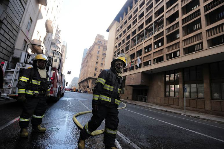 Firefighters on the scene at the Gauteng Premier's office in Johannesburg on 30 June after a fire broke out in the morning.