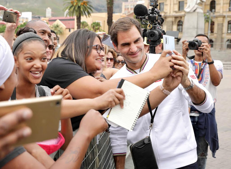 A file photo of Roger Federer taking selfies with fans in February 7 2020.