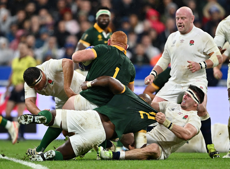 Steven Kitshoff and Mbongeni Mbonambi of South Africa take on Tom Curry of England during the Rugby World Cup 2023 semifinal match at Stade de France on October 21 2023 in Paris.