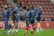 Kgaogelo Chauke (No.72) warms up with his Southampton teammates before a Premier League match against champions Liverpool at home at St Mary's on the south coast. 