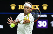 Rafael Nadal of Spain plays a forehand in his third round match against Lorenzo Sonego of Italy at The Championships Wimbledon 2022 on July 2 2022.