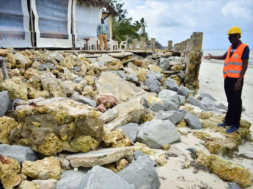 Lands executive Edward Nyale at the site of collapsed Big Tree restaurant that encroached the ocean. /JOHN CHESOLI