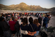 Hout Bay residents take part in a candlelight vigil for Nick Frischke, a 22-year-old German tourist who disappeared during a hike last month, in Cape Town.