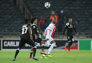 Issa Sarr and Justin Shonga of pirates in action with Tendai Ndoro of Ajax during the Nedbank Cup Last 32 match between Orlando Pirates and Ajax Cape Town at Orlando Stadium on February 10, 2018 in Johannesburg, South Africa. 